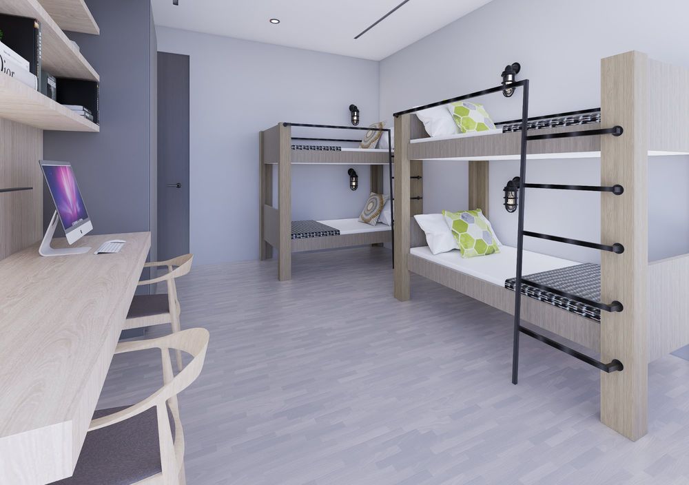 Render of a trainee room with wooden bunk beds and a study desk along one wall